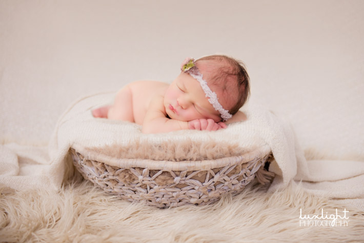 newborn photography session with basket