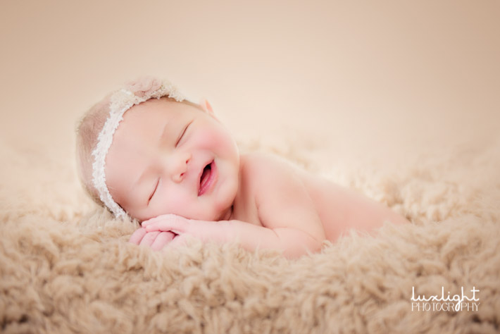 newborn baby in fur for photography session