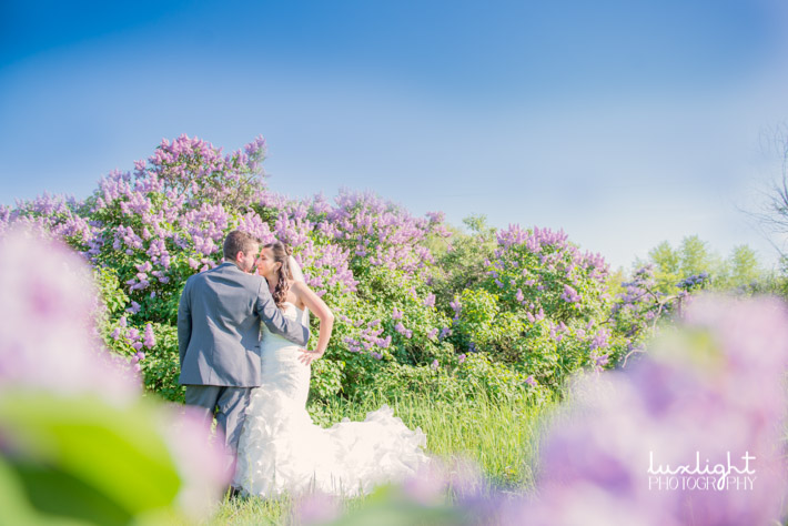 lilac spring wedding photo with bride and groom