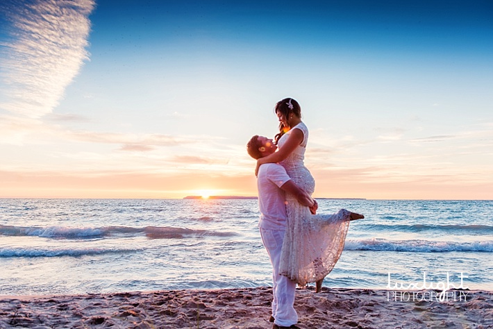 bride and groom celebrate on beach
