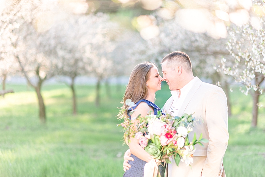 summer engagement portrait pictures in northern michigan during cherry blossoms