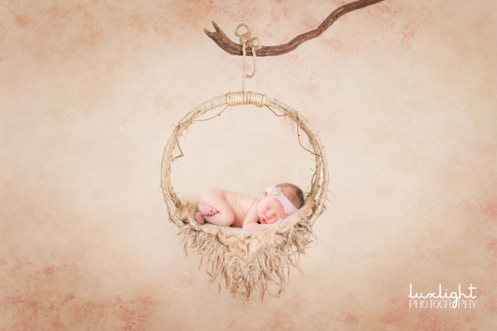 newborn photographer idea of baby in dreamcatcher