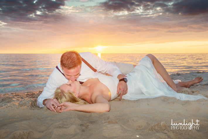 romantic wedding photo of bride and groom at sunset