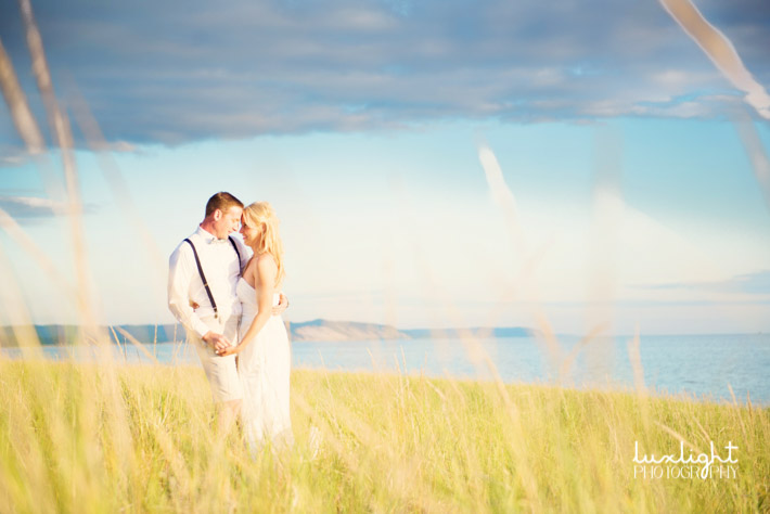 beach wedding photo of bride and groom at sunset
