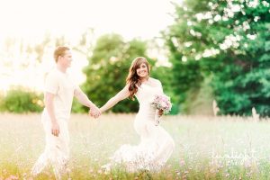 bride and groom in field photo
